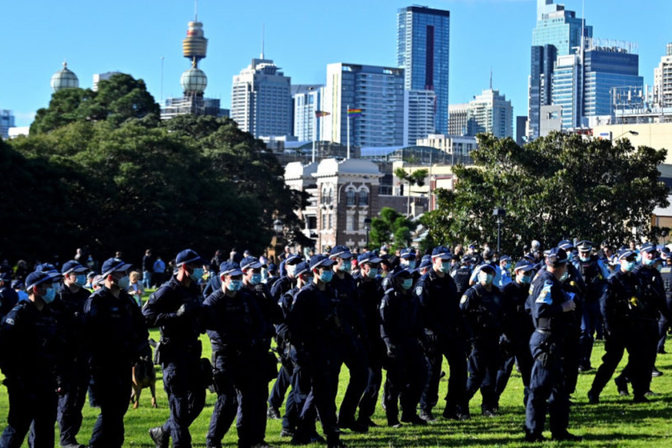 A line of police confronts protesters at last Saturday's anti-lockdown rally.