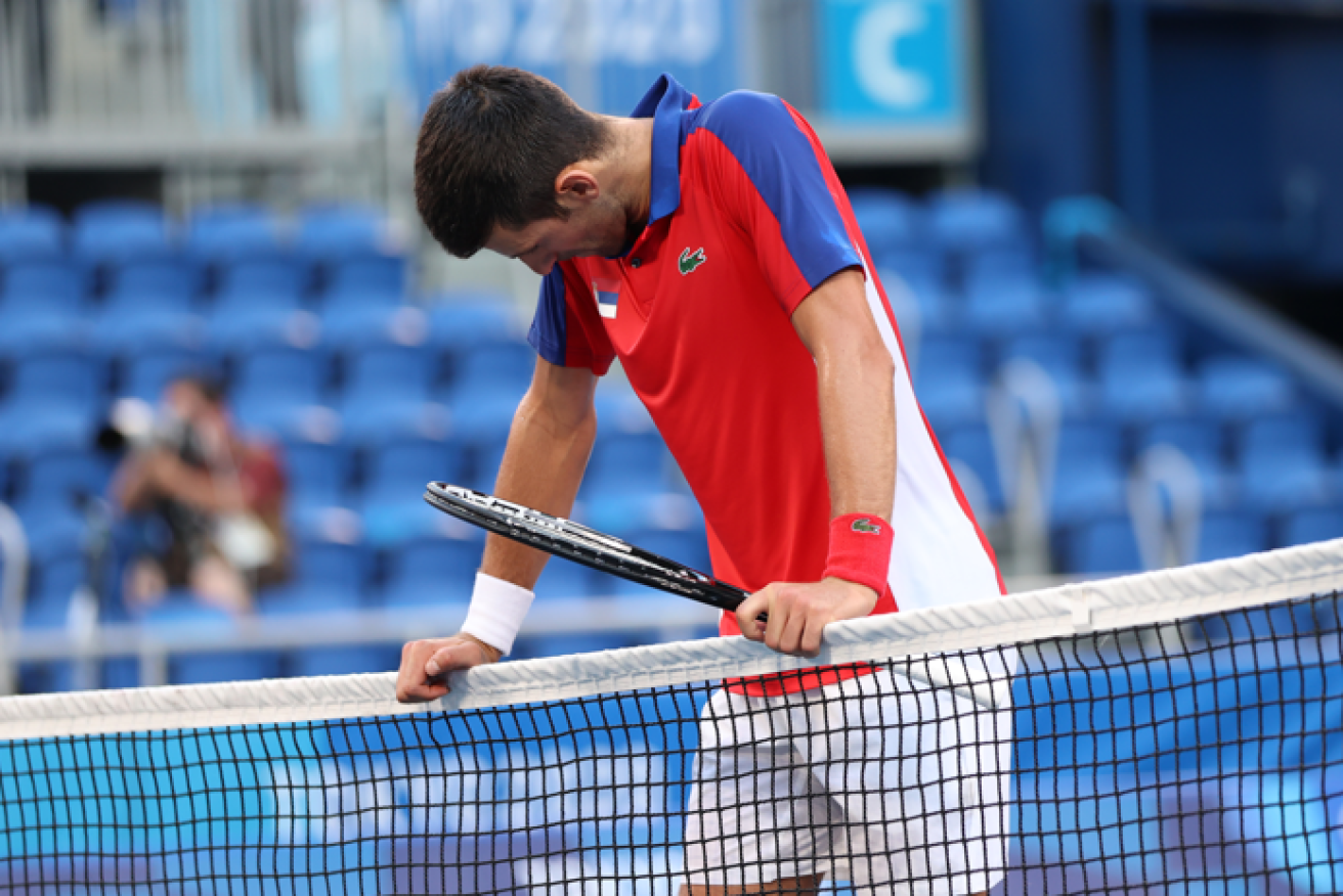 Novak Djokovic hangs his head defeat and despair after blowing his chance for bronze.