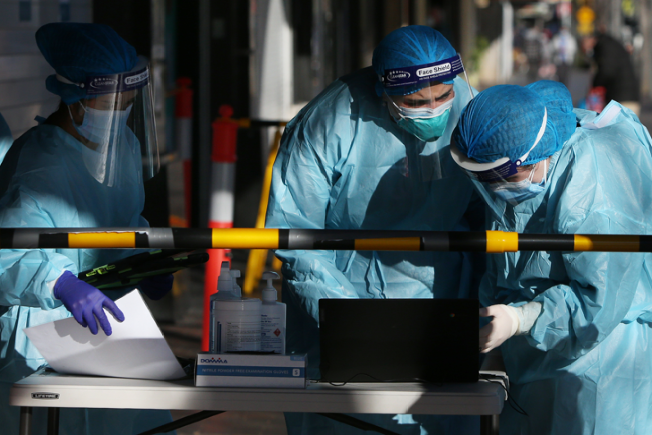 Medics help anxious residents of Fairfield, one of locked-down Sydney's hotspots.