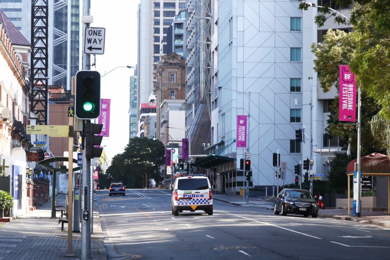 Police patrol an empty Brisbane central business district on Sunday.