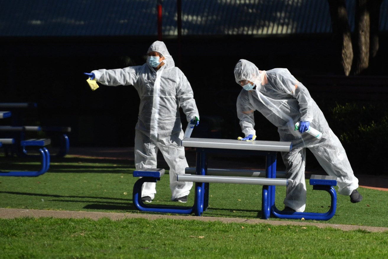 Cleaners in personal protective equipment eradicate any traces of the virus at Strathfield South Public School in Sydney on Monday.