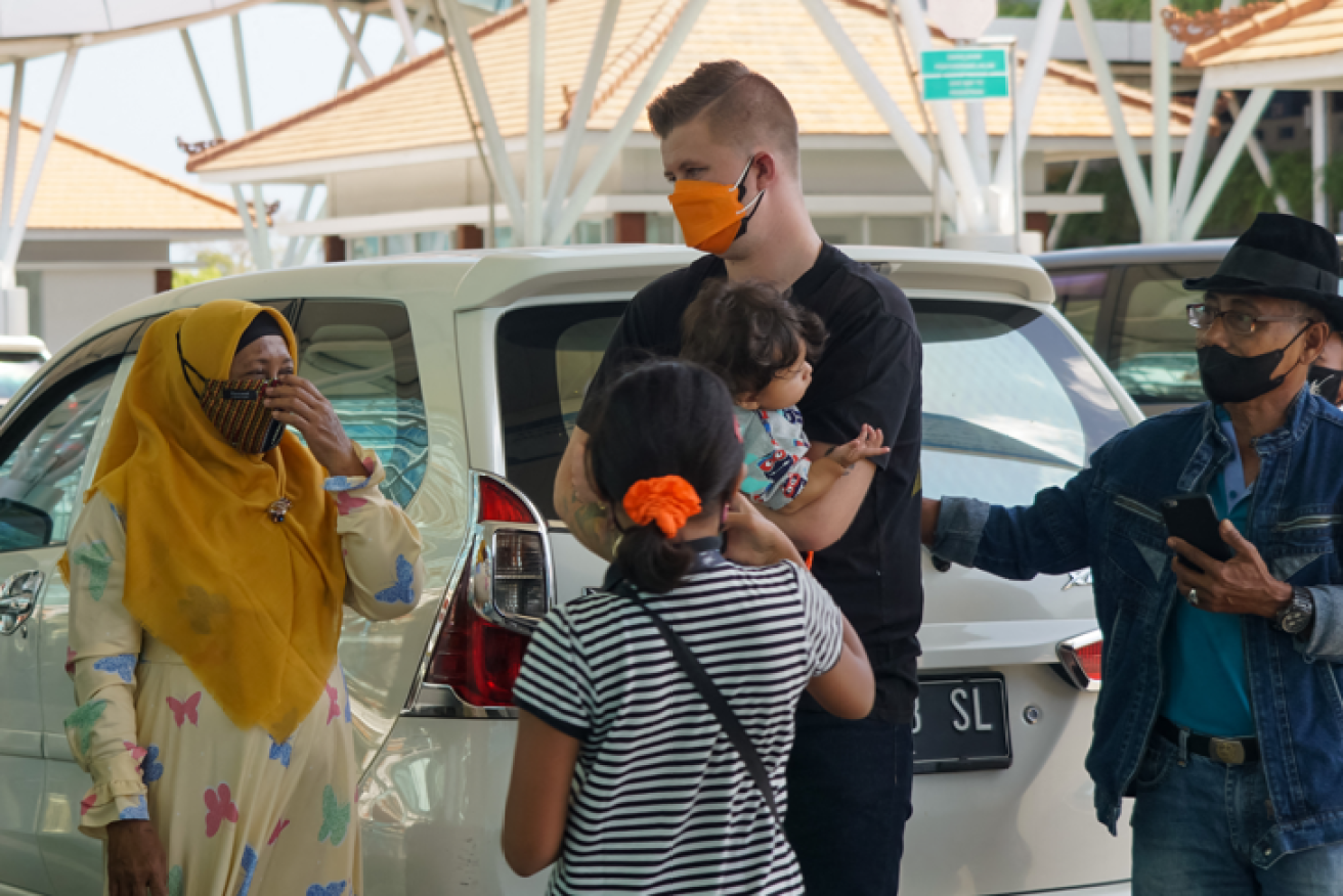An Australian family bids farewell to Balinese friends before the long-awaited flight home.