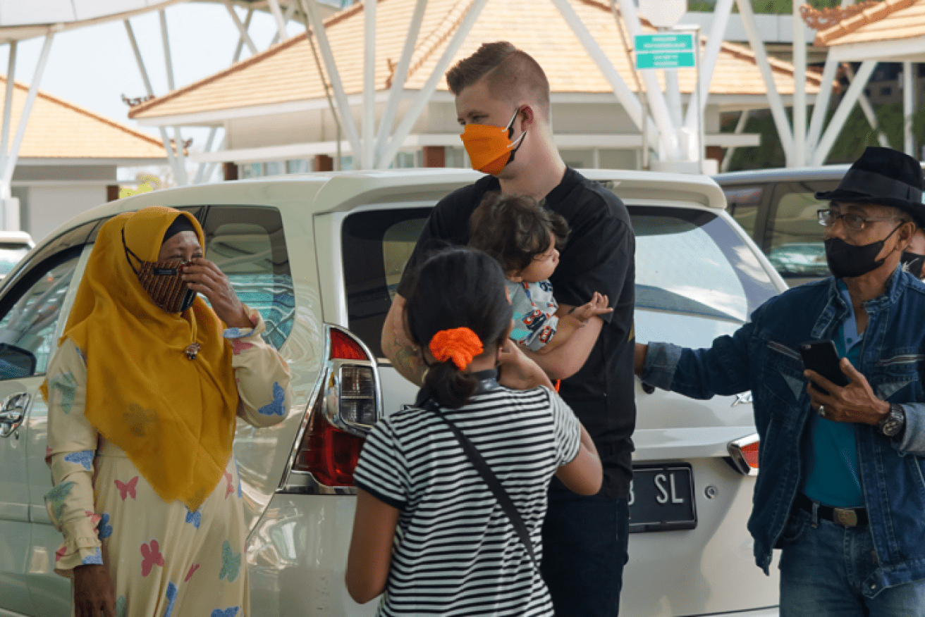 An Australian family bids farewell to Balinese friends before the long-awaited flight home.