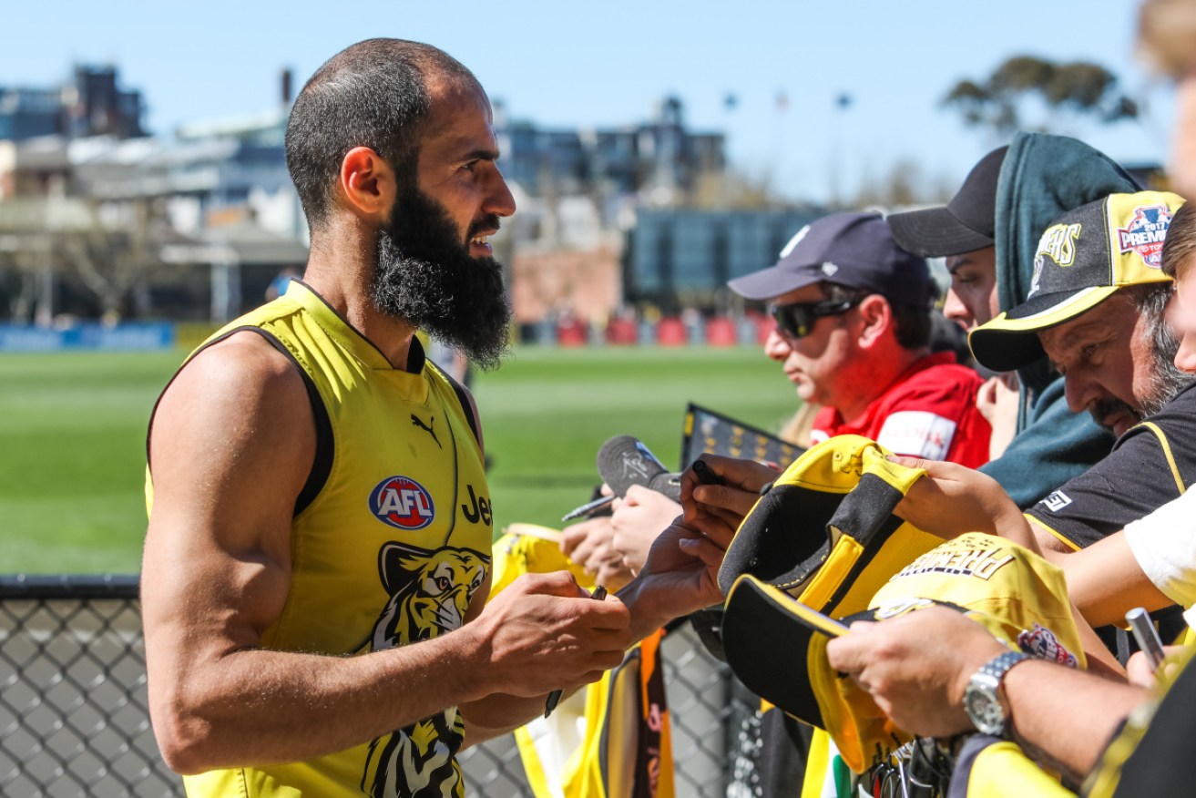Bachar Houli signs autographs at a Richmond training session in 2019.