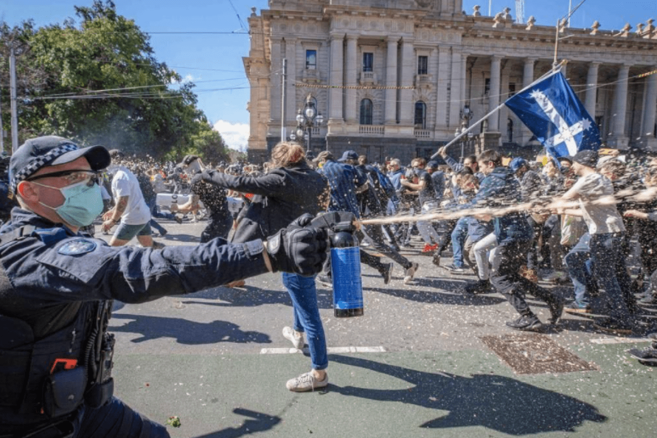 Protesters get doused with pepper spray in wild scenes outside the Victorian parliament.