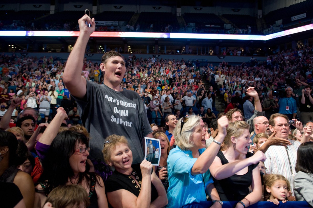 Mr Vovkovinskiy cheers as Barack Obama arrives at a presidential election rally in 2009.