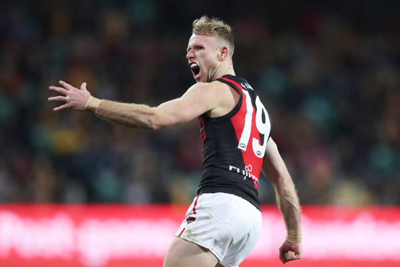 Essendon's Nick Hind has a good reason to scream after being denied entry to Tasmania because he picked up lunch at a mall a COVID case is known to have visited.