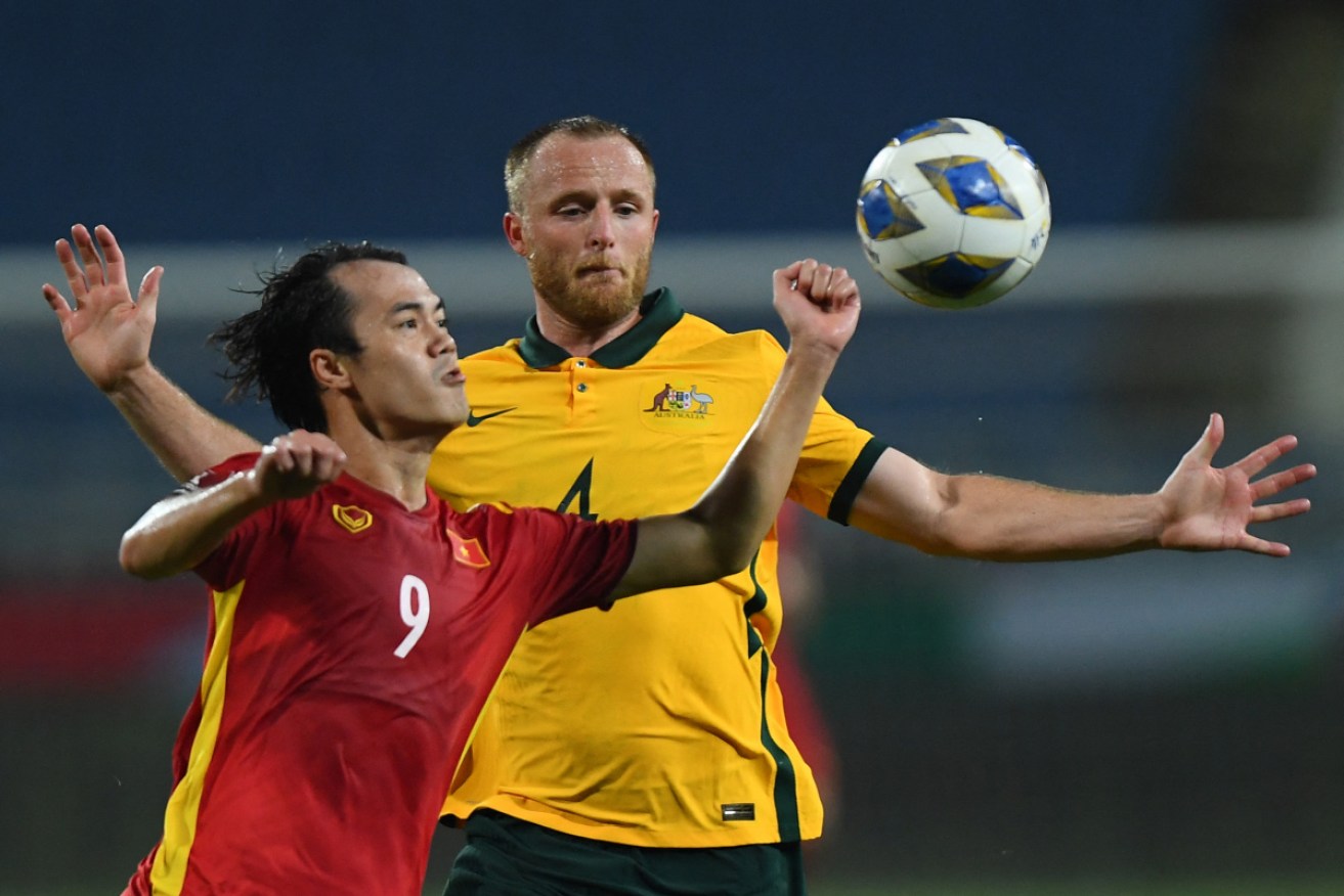 Vietnam's Van Toan Nguyen tussles with Australia's Rhyan Grant  in Hanoi on Tuesday night.