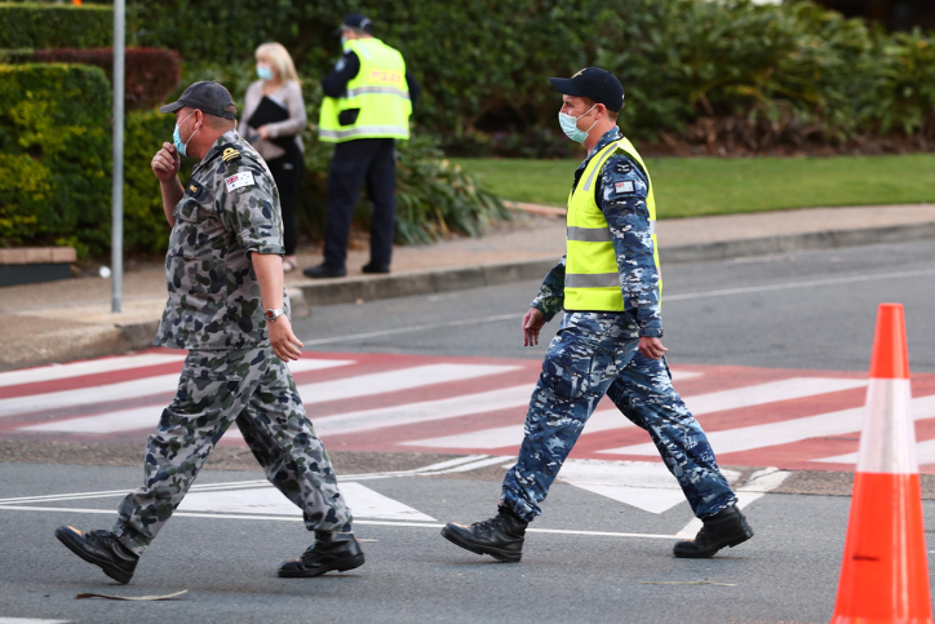 Troops help seal the Qld-NSW border as one infection grows to three. 