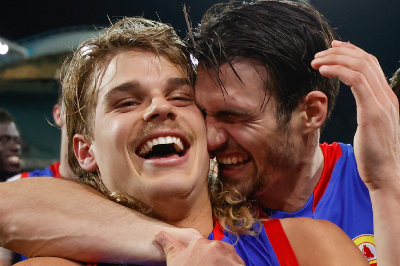 First season phenom Bailey Smith (left) and veteran Easton Wood celebrate the Bulldogs' ruthless demolition of Port Adelaide.
