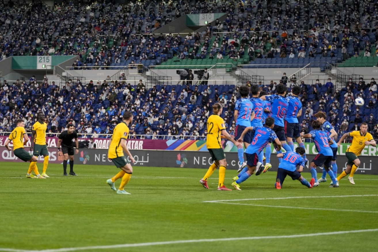 Ajdin Hrustic beats the wall with his free kick to score Australia's goal in the 2-1 loss to Japan. 