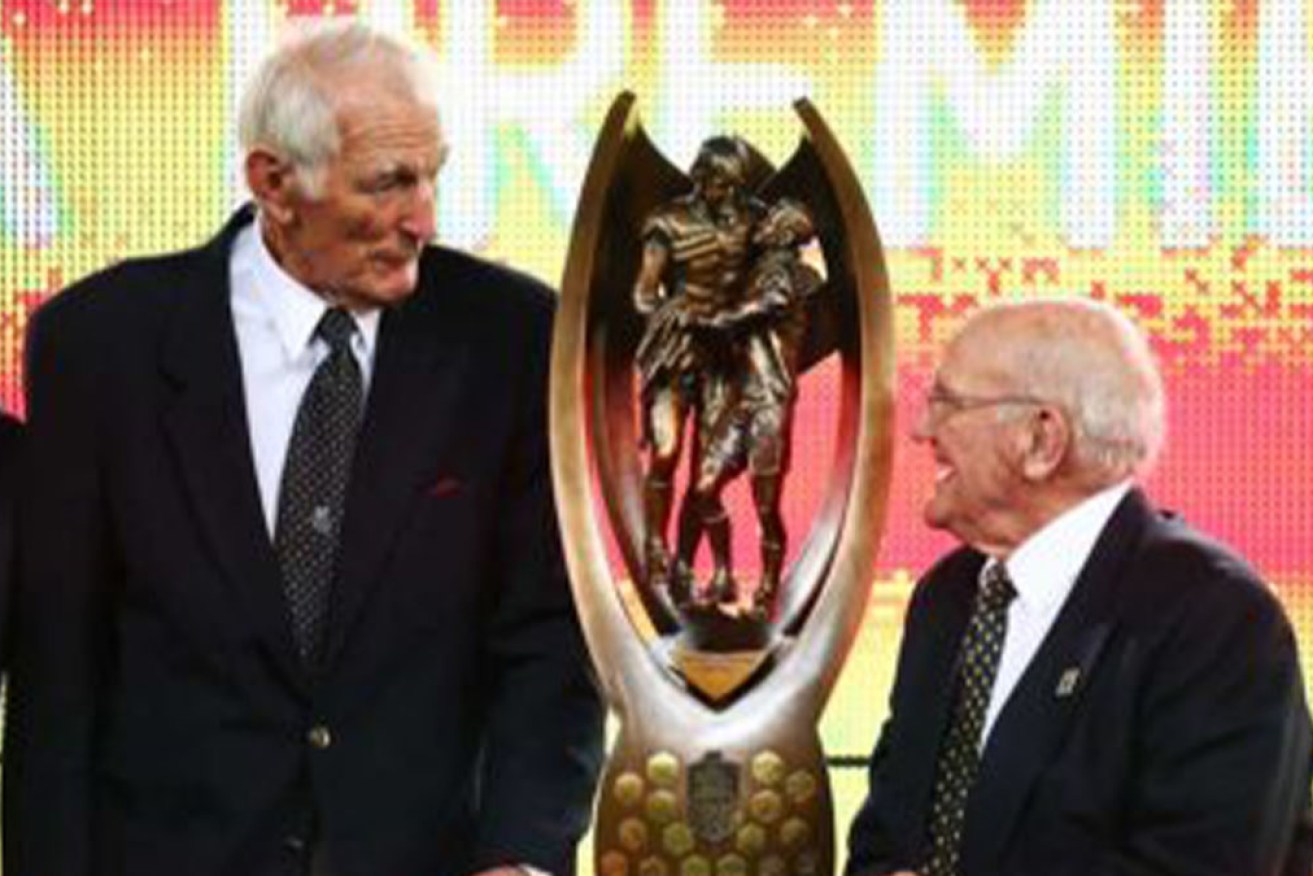 Norm Provan (left) and Arthur Summons with the NRL trophy that bears their names, at the 2013 grand final.