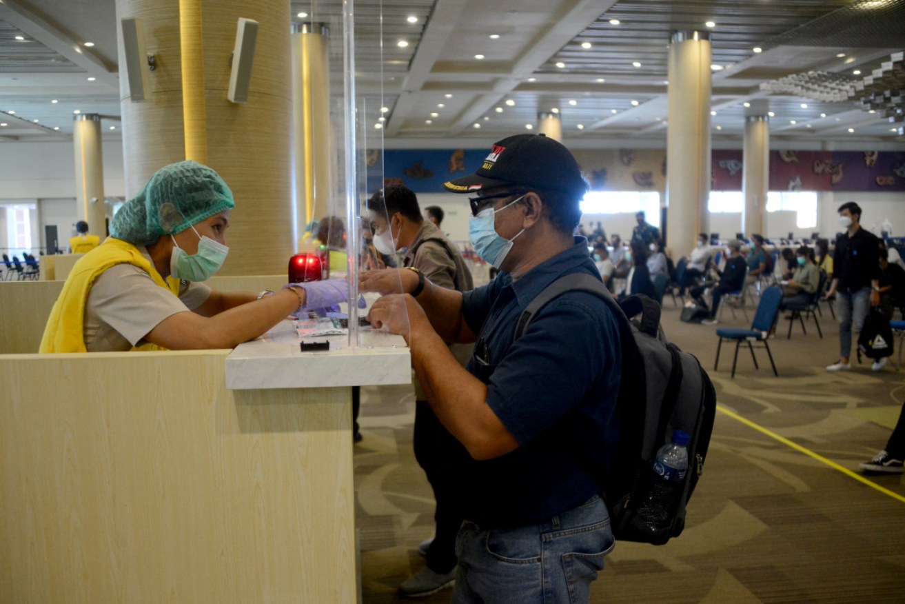 He's no tourist: A man involved in a simulation of Bali's reopening at Ngurah Rai international airport this week.