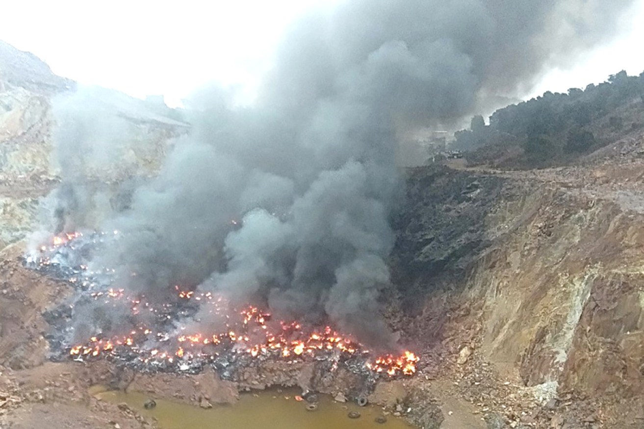 About 1500 car and truck tyres are burning at the Mount Lyell mine on Tasmania's west coast.