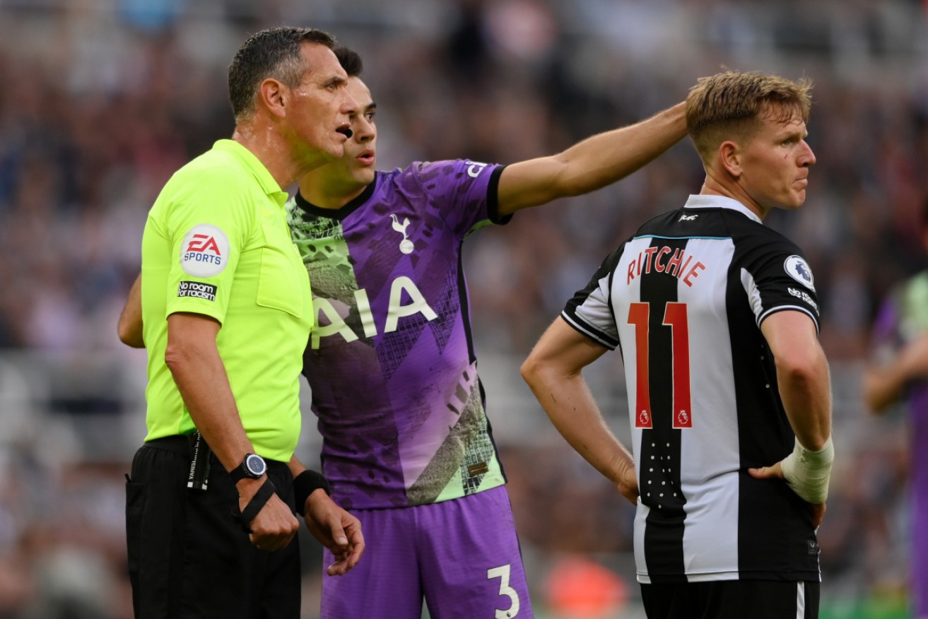 Tottenham Hotspur's Sergio Reguilon points out an issue in a fan in the stands to referee Andre Marriner.