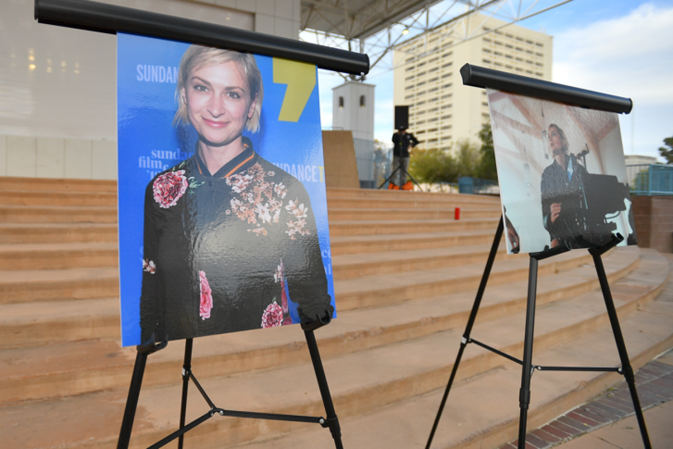 Photos of tragic cinematographer Halyna Hutchins are displayed before a vigil held to honor her at Albuquerque Civic Plaza.