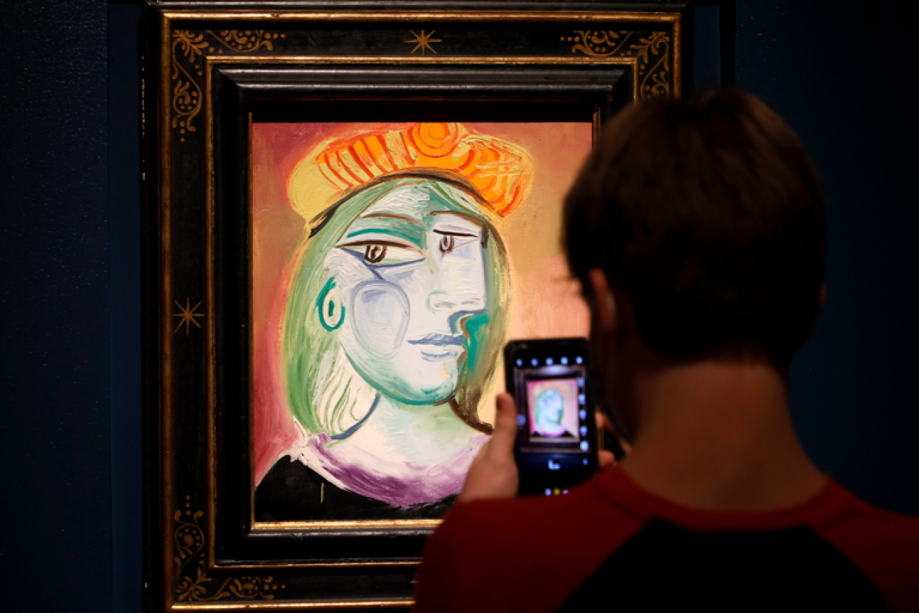 This Vegas visitor can keep his photo of "Femme au beret rouge-orange" but the real thing is worth millions.