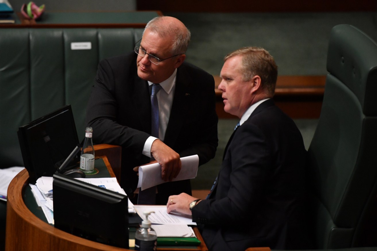 Tony Smith in conversation in the House with Scott Morrison. Mr Smith will resign as Speaker next month.