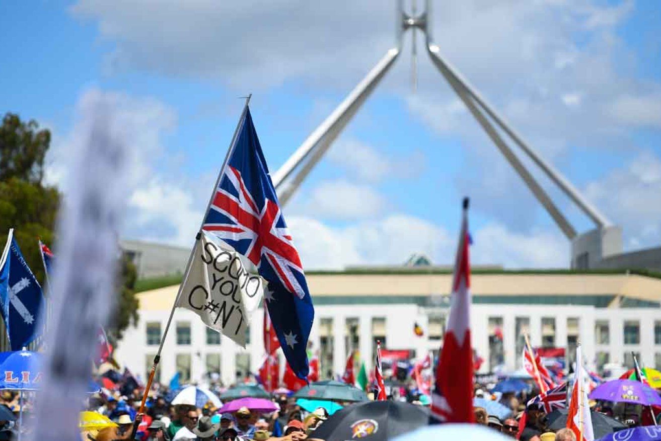 Thousands of protesters chanted 'Sack them all' outside federal parliament.
