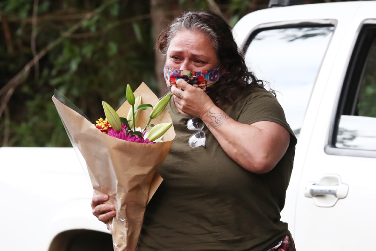 Flowers watered with tears at the scene where twin 4-year-old twins perished in a house fire.