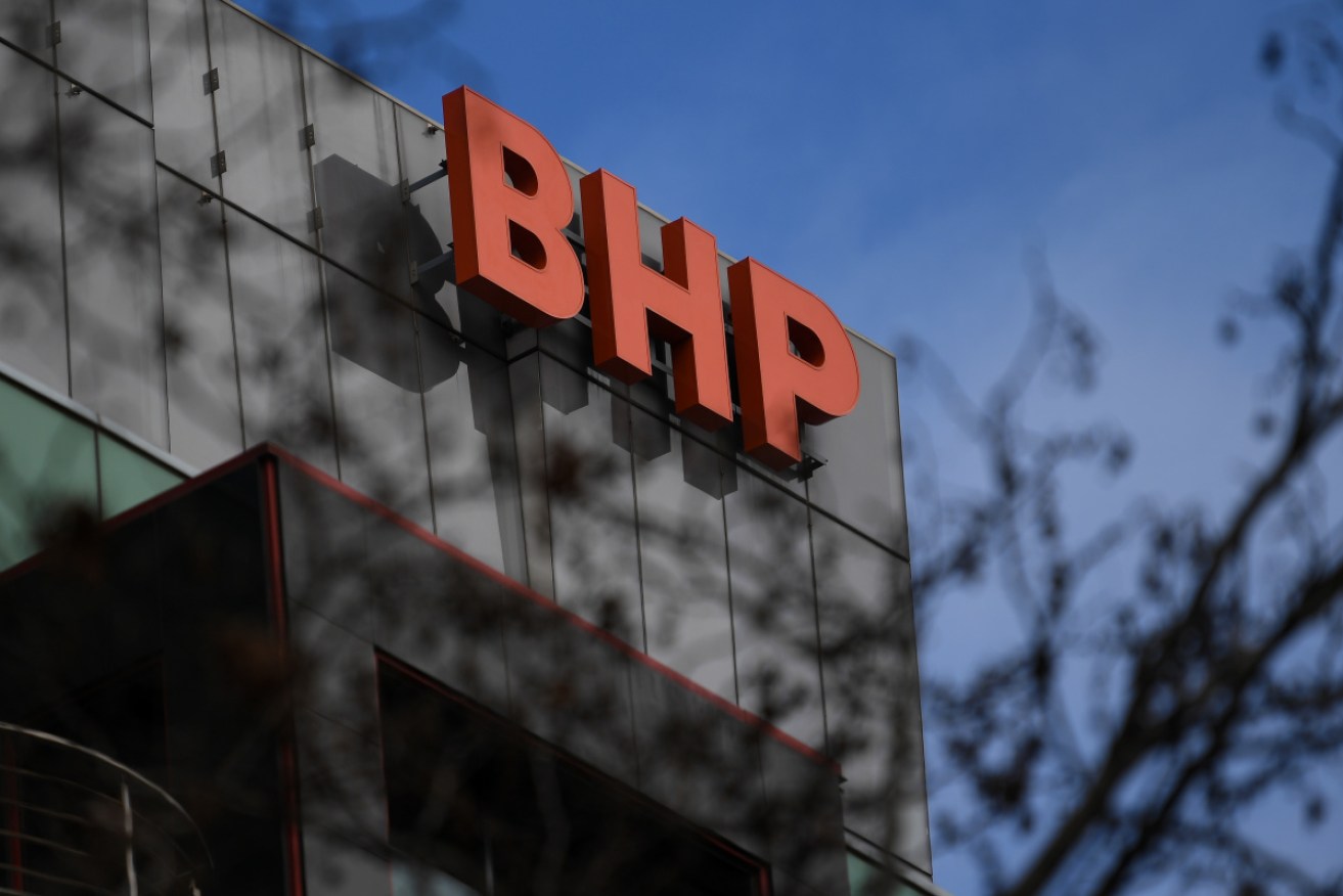 Profits are down at BHP on lower commodity prices, but the mining giant says it is managing global and local inflationary pressures better than its rivals.