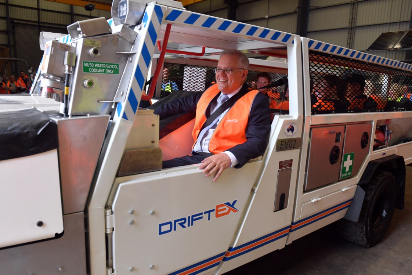 Scott Morrison tries out an electric vehicle at a renewable engineering facility in the Hunter.