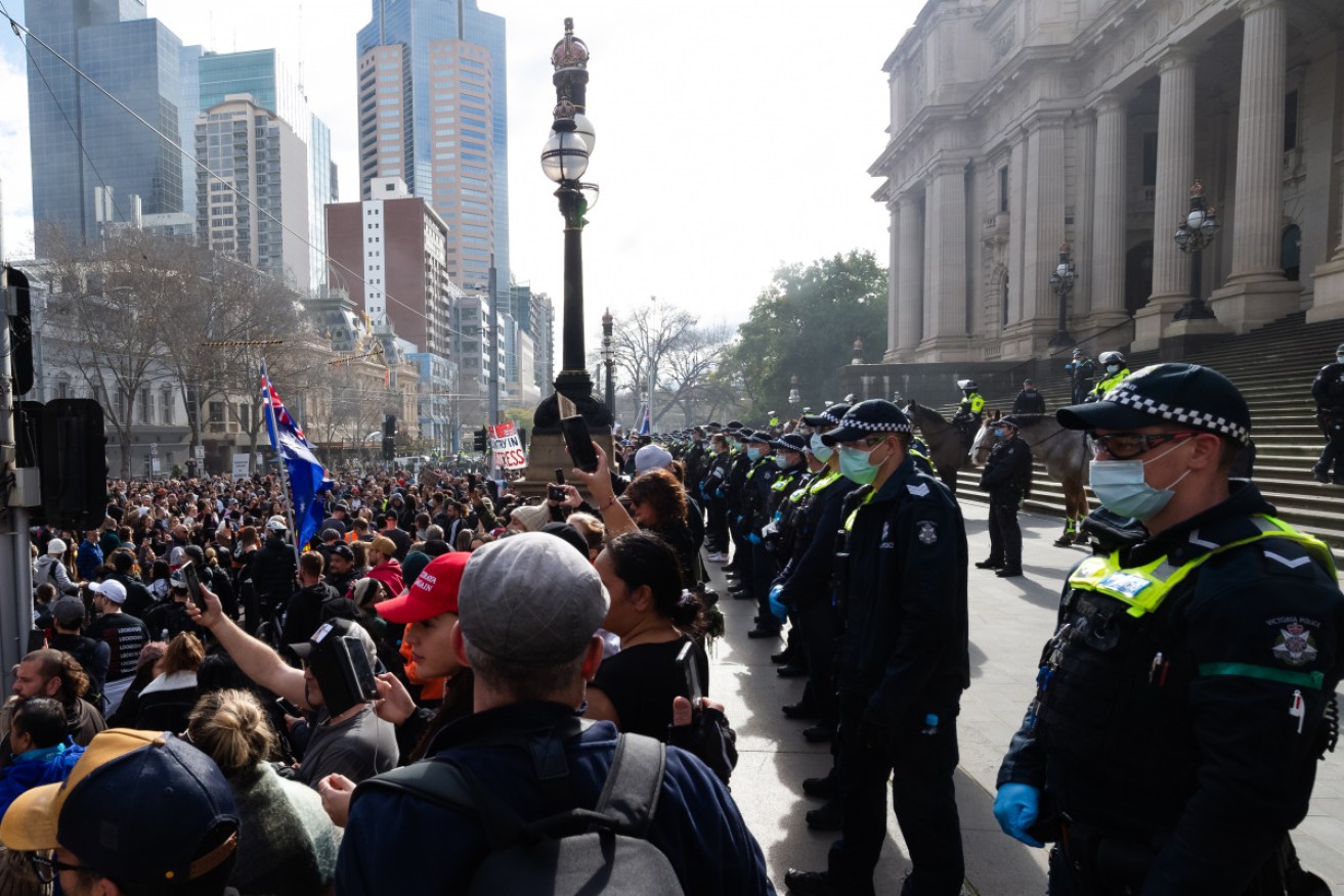 Protesters and police outside the Victorian parliament at a anti-lockdown rally in July.