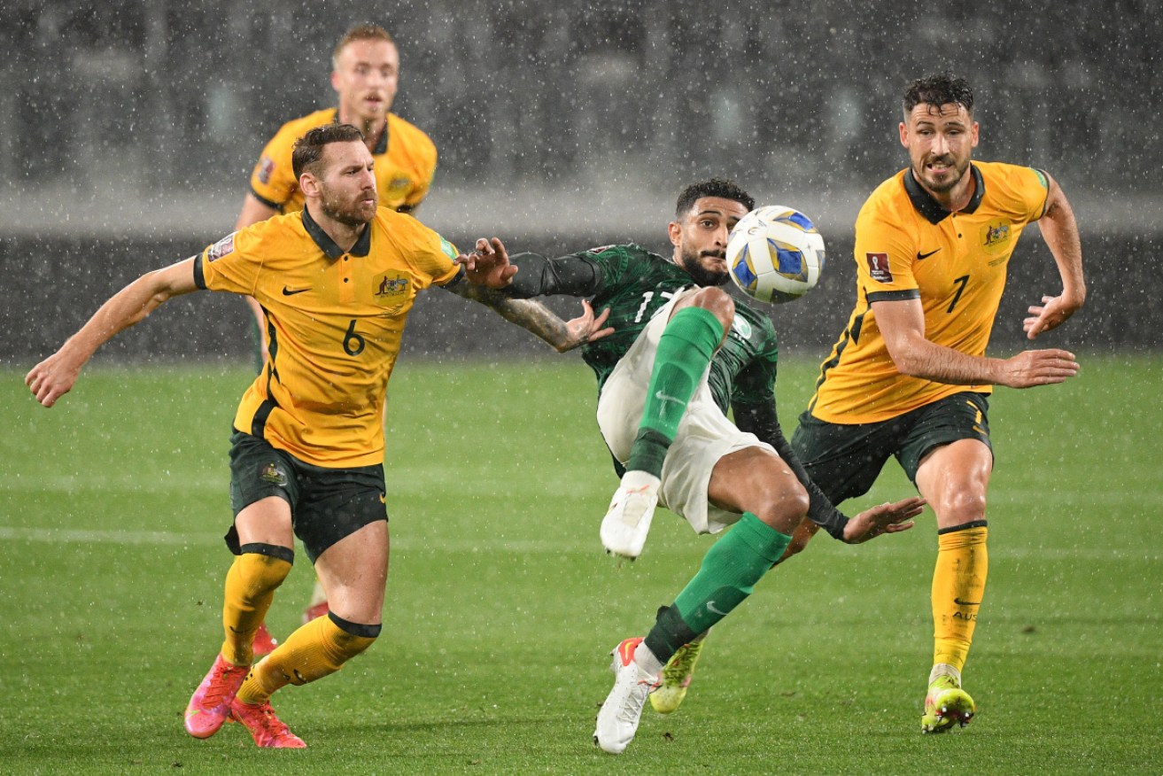 The Socceroos and Saudi Arabia have played out a 0-0 draw in a rain-soaked World Cup qualifier.