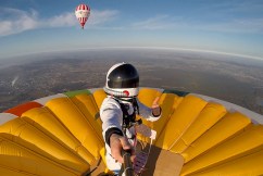 Daredevil stands atop hot-air balloon, sets record