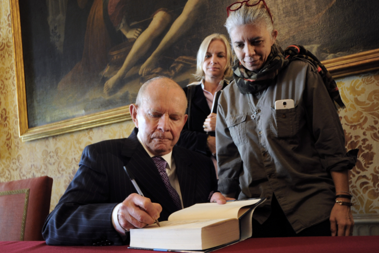 Wilbur Smith, shown here 2013, autographs one of the 140 million books he sold.