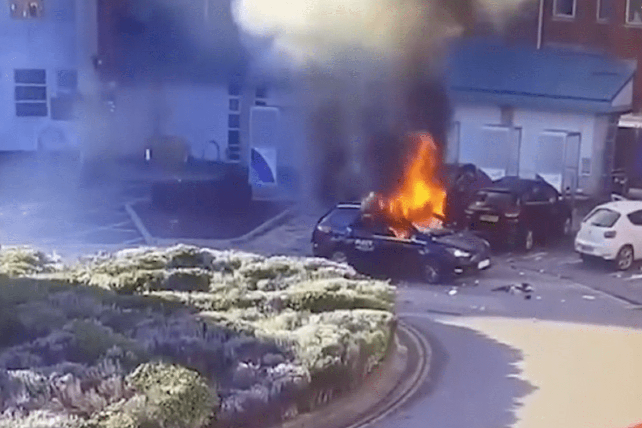 Dramatic CCTV footage shows the taxi driver running from the smoking car before it bursts into flames. 