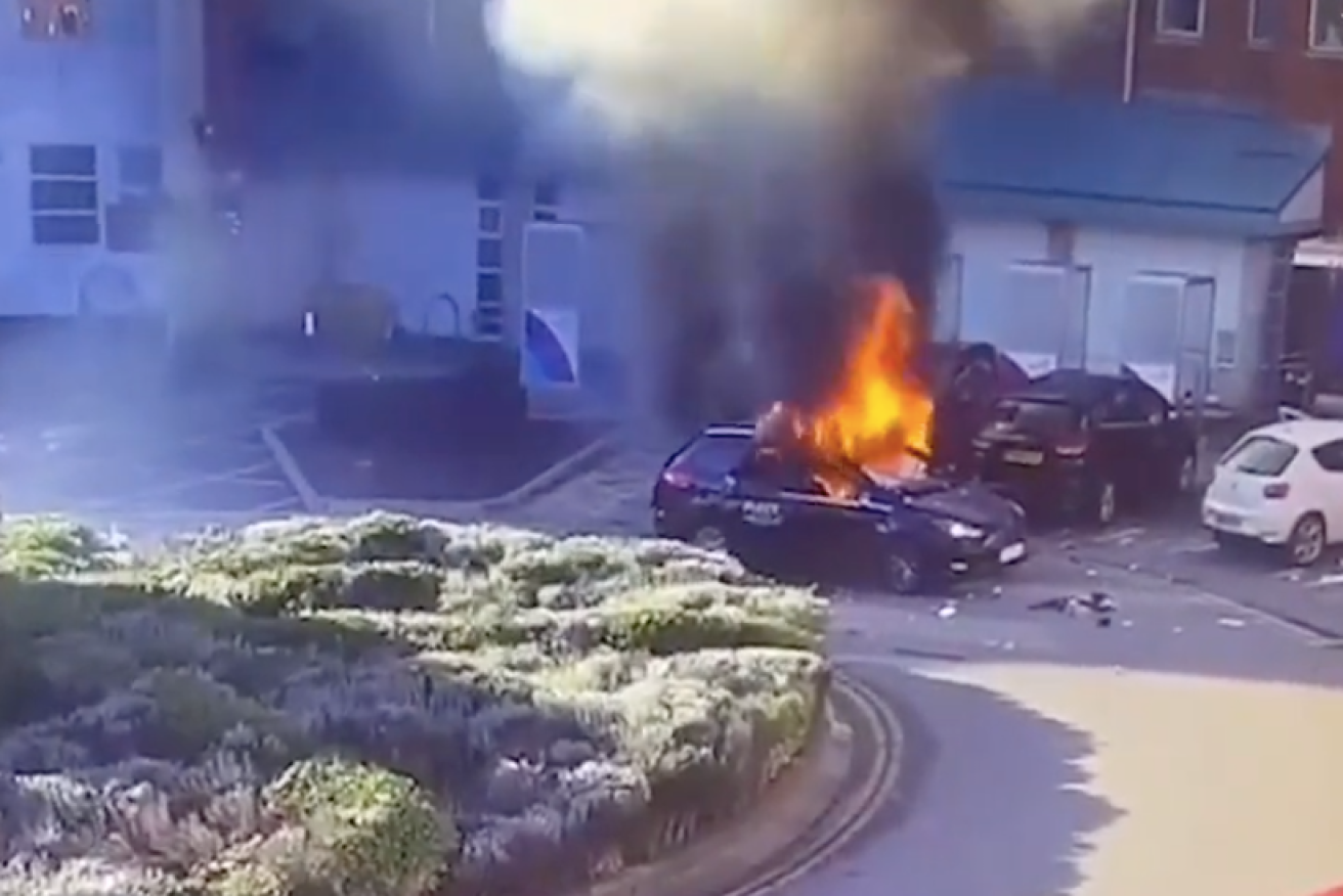 Dramatic CCTV footage shows the taxi driver running from the smoking car before it bursts into flames. 