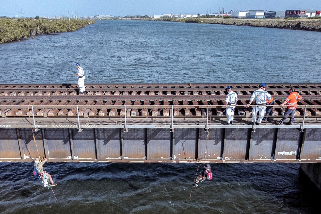 Dangling from bridges, like this 2021 Newcastle protest, is a favourite Blockade Australia tactic.<i>Photo: Blockade Australia</i>