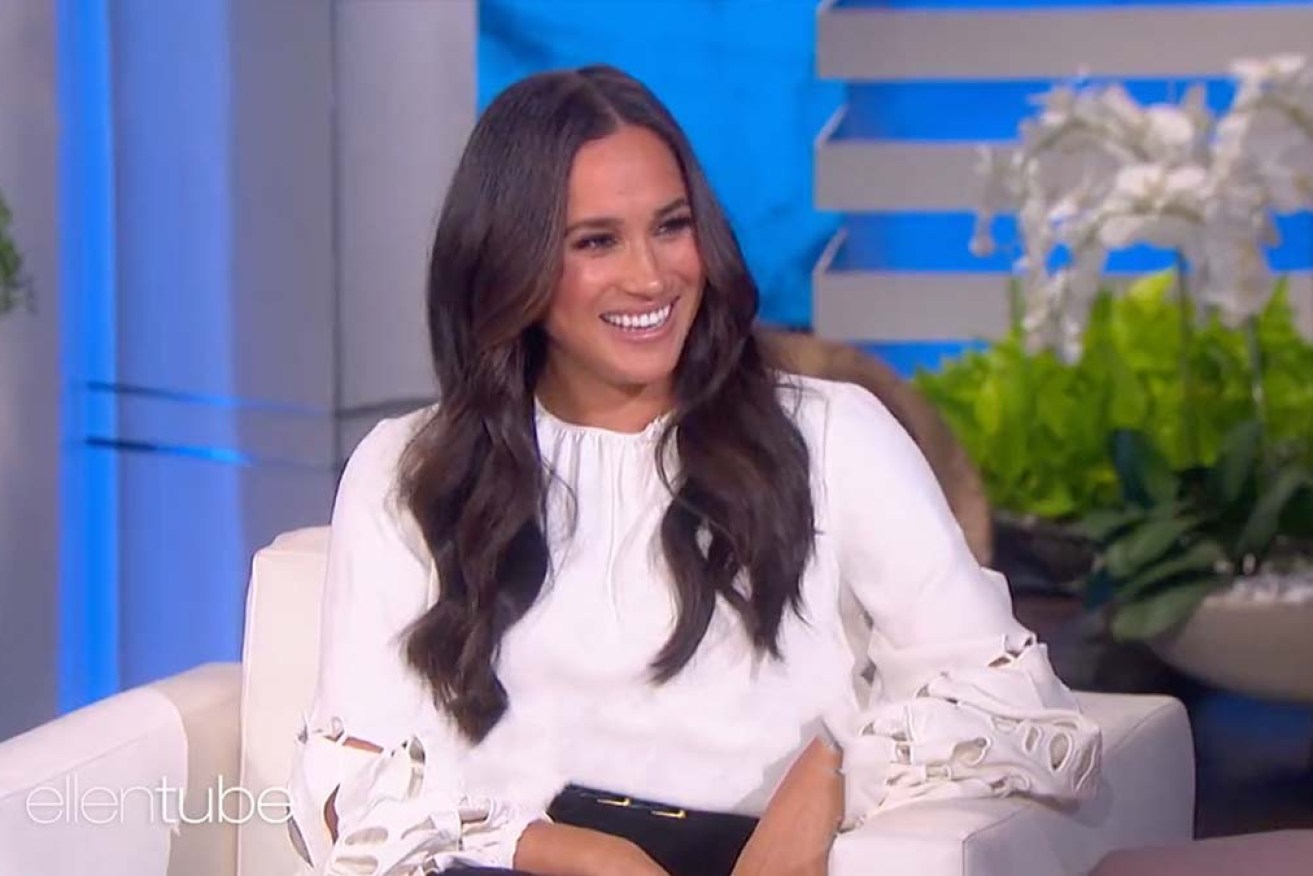 Meghan Markle, in a $4000 Oscar de la Renta white blouse, on the Warner Bros set with Ellen DeGeneres.