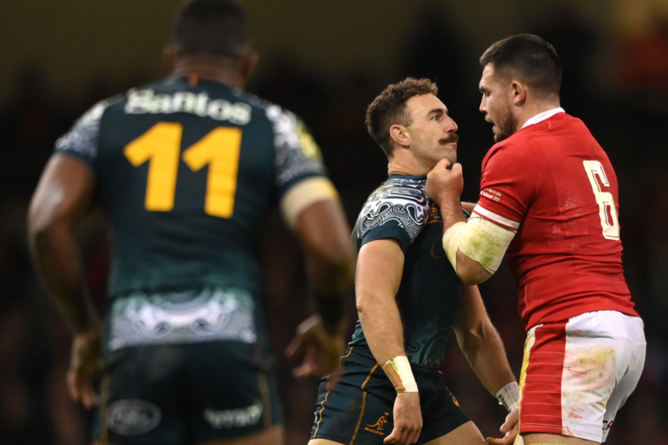 Wallabies scrum half Nic White has a close and personal encounter with Wales flanker Ellis Jenkins.