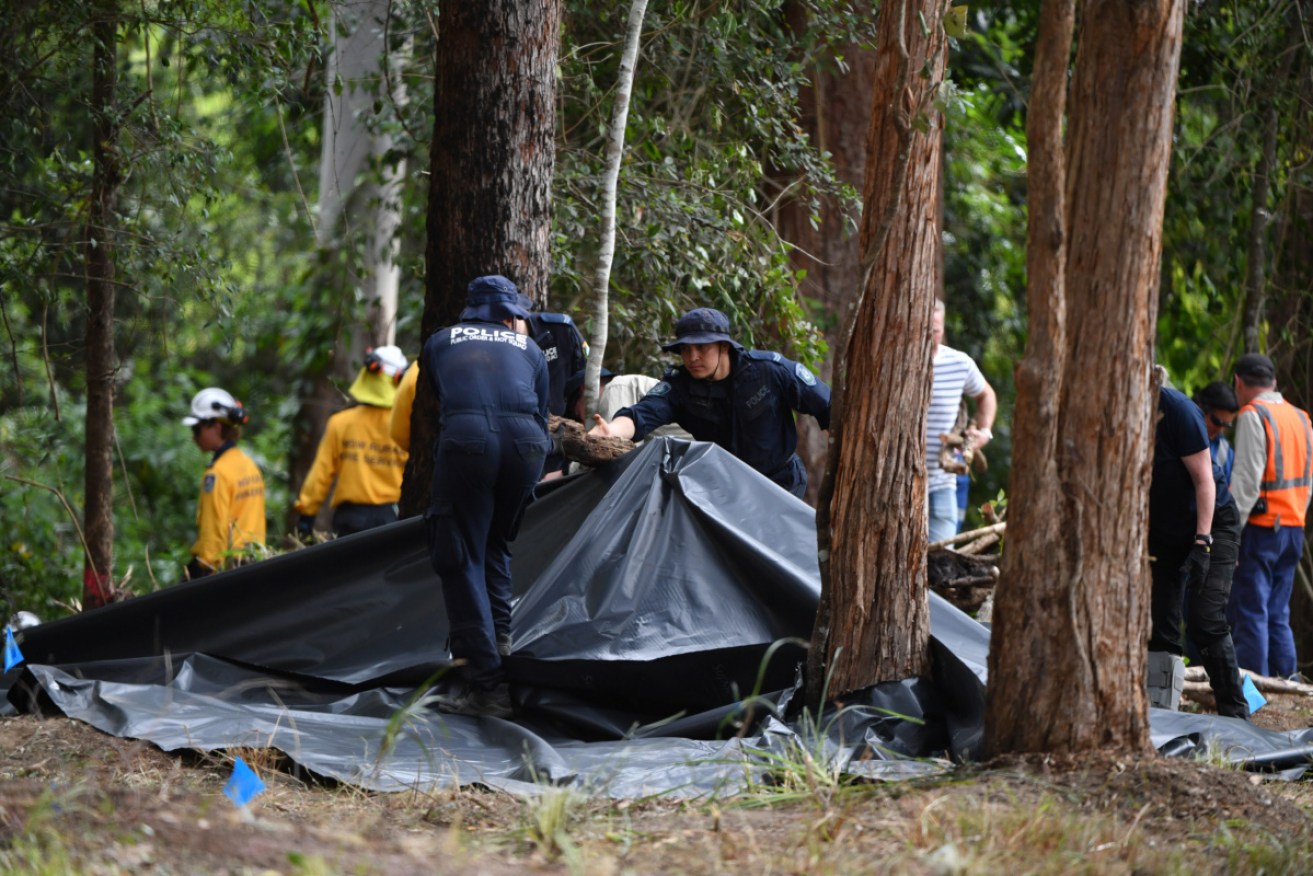 Police on the search ground last week. They found more potential evidence on Tuesday.