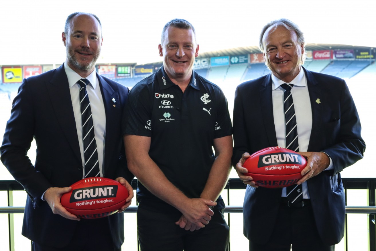 President Luke Sayers, newly appointed Carlton Senior Coach Michael Voss and CEO Brian Cook (far right), pictured with president Luke Sayers and coach Michael Voss, has tested positive.