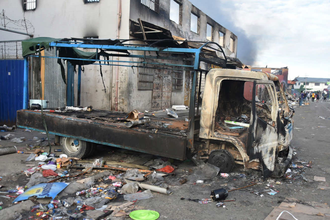 A burnt out truck stands among the ruins of Honiara, the Solomon Islands' ravaged capital.