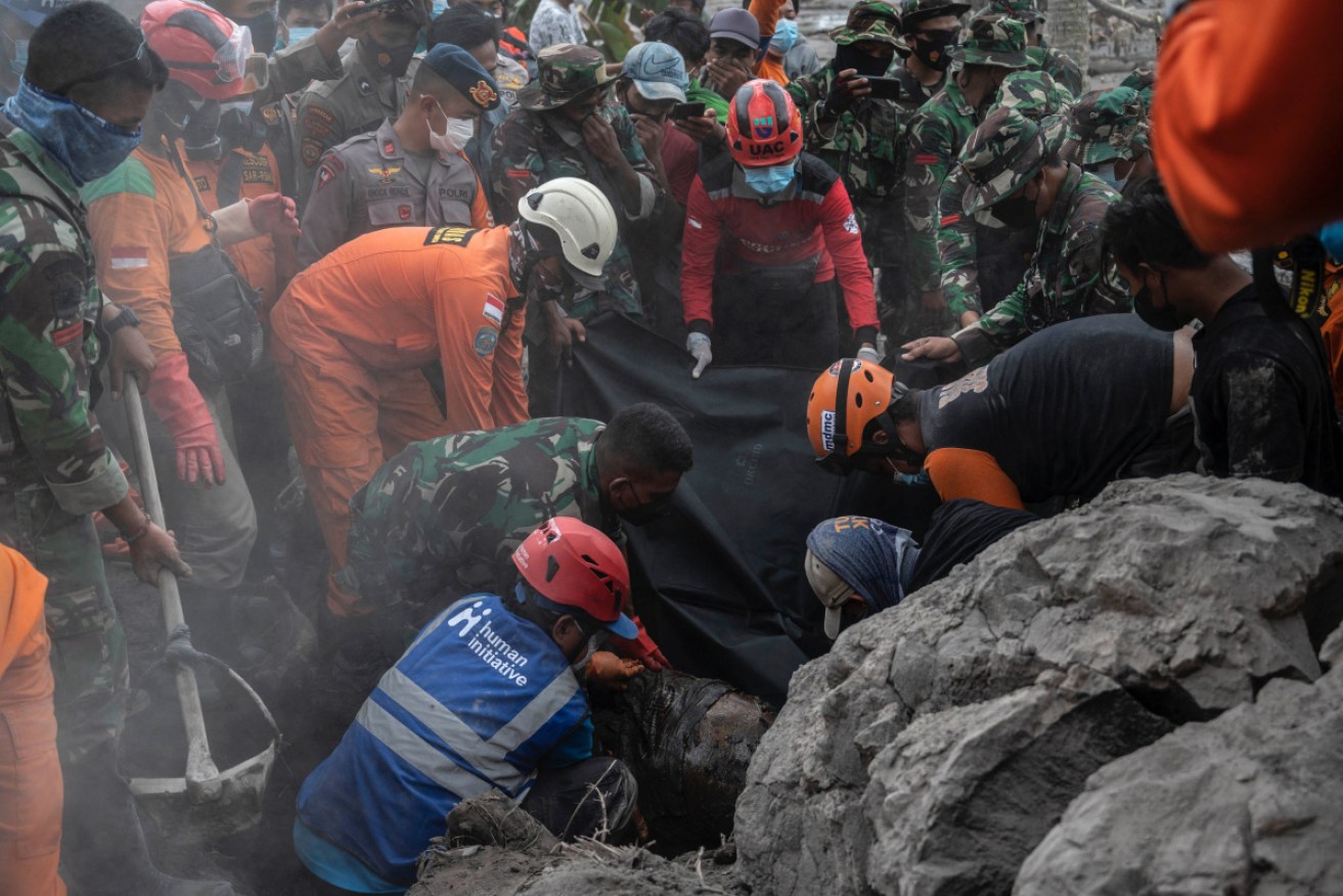 A body is recovered in Sumberwuluh village, one of the areas hardest hit in Saturday's deadly eruption.