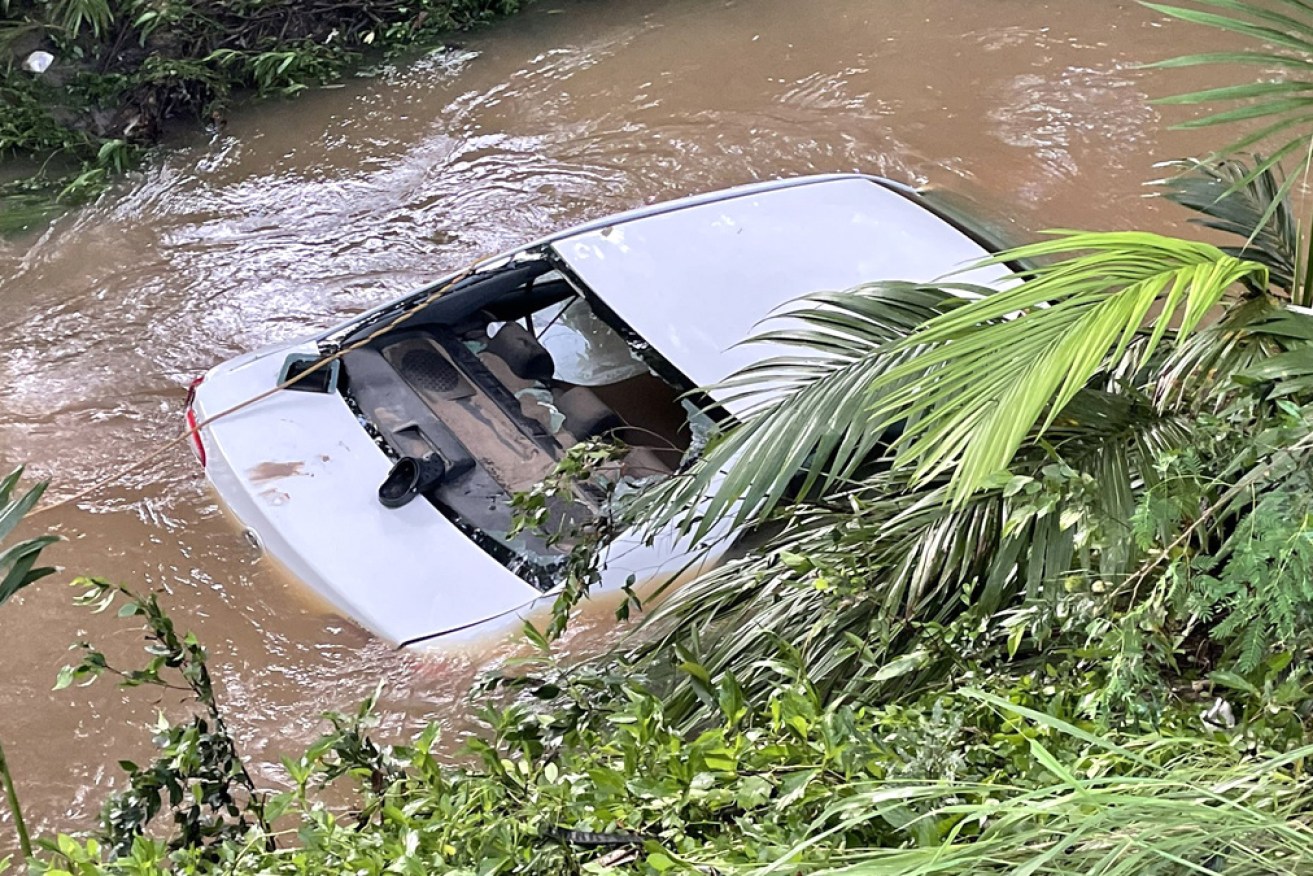 The woman died after the car she was in was swept away by floodwaters.
