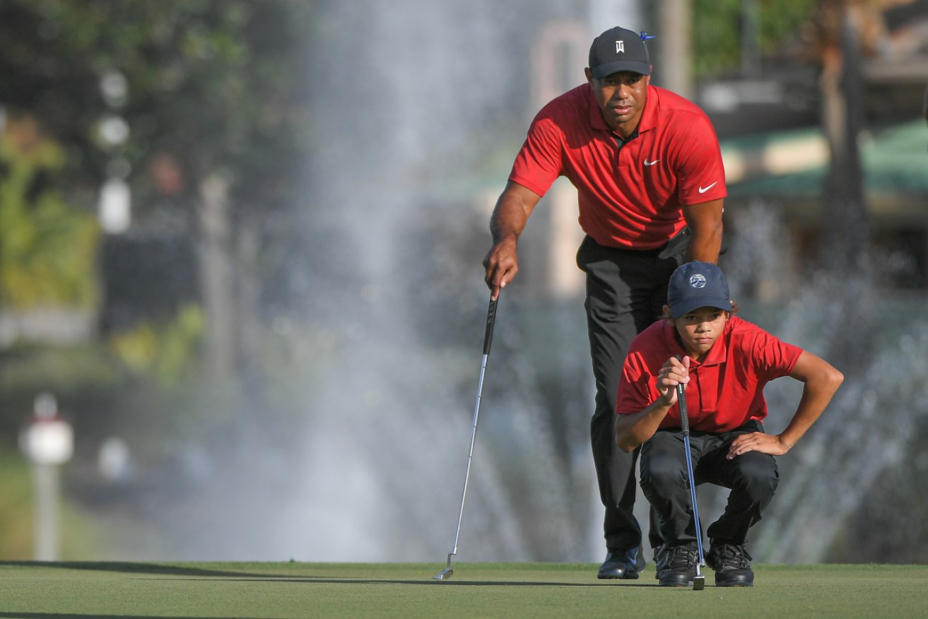 Tiger Woods and son Charlie on the green at the PNC Championship in Florida.
