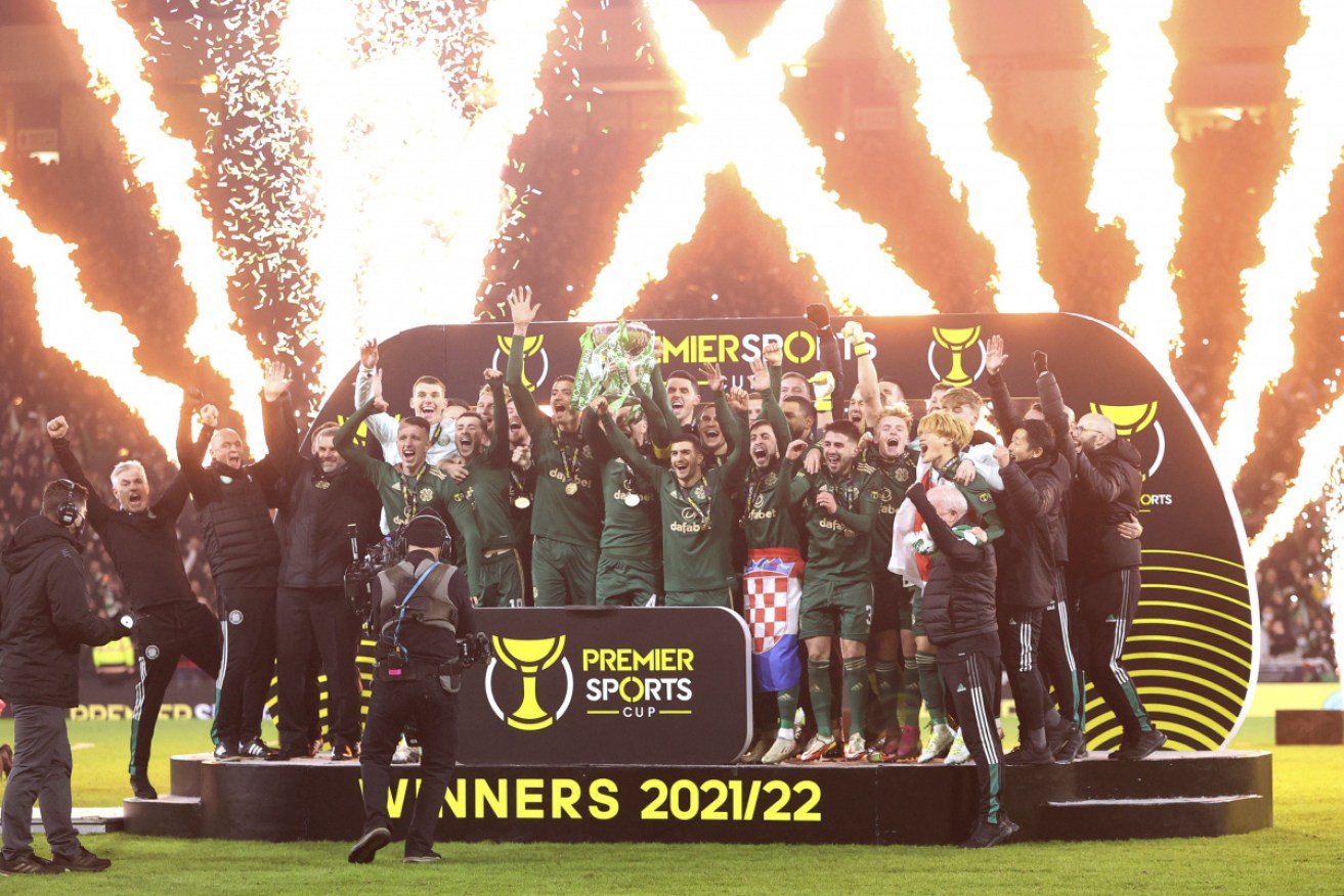 Ange Postecoglou (third from left) and Celtic celebrate their Scottish League Cup Final win at Hampden Park.