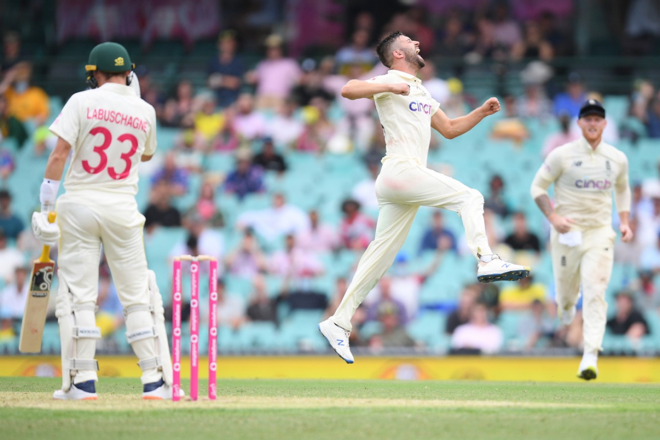 Mark Wood enjoys taking the wicket of Marnus Labuschagne at the SCG on Wednesday. 