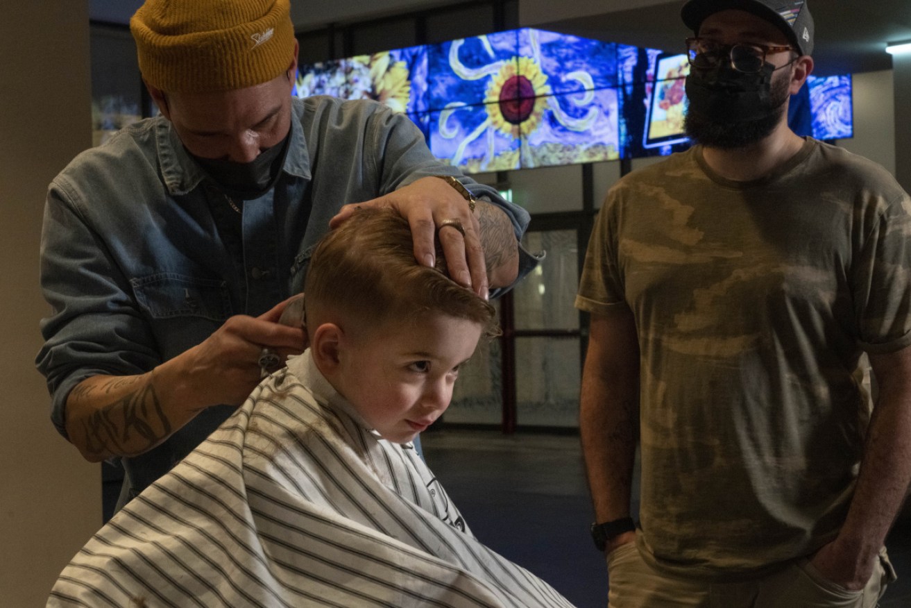 Three-year-old Ole van Santen gets a haircut at the Van Gogh museum in Amsterdam.