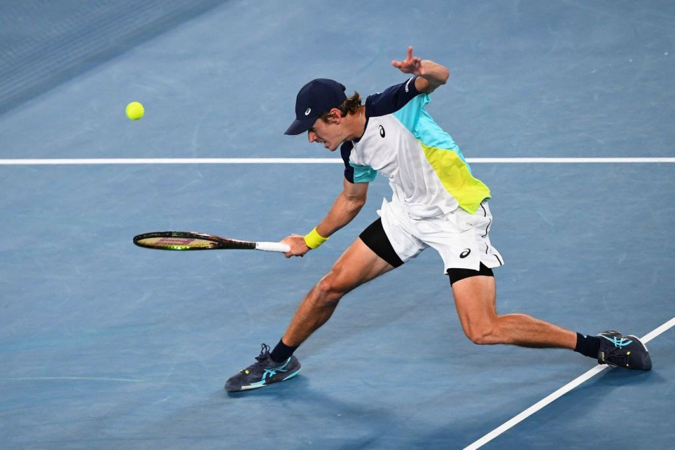 Australia's Alex De Minaur hits a return against Spain's Pablo Andujar on day six. 