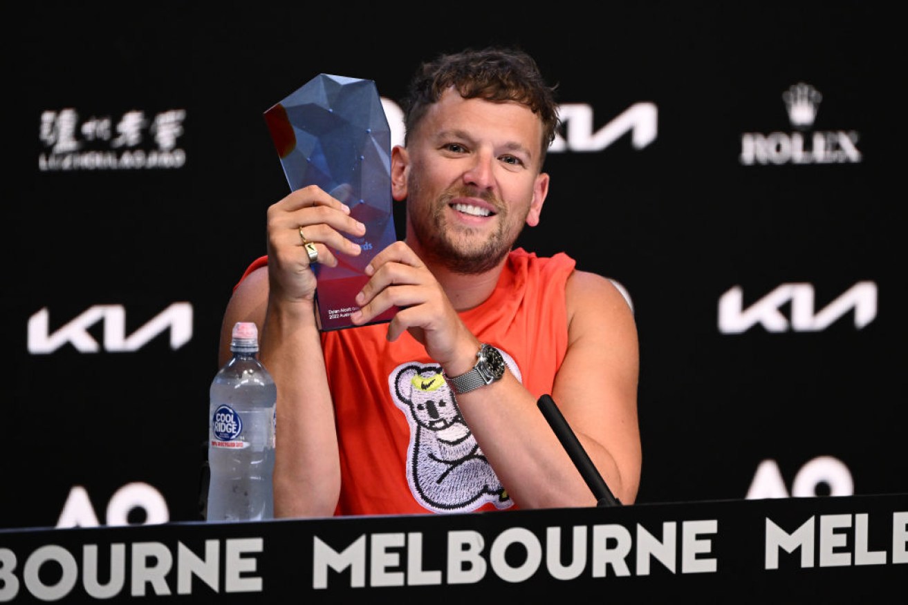 Dylan Alcott holds his 2022 Australian of the Year trophy ahead of his Australian Open final.