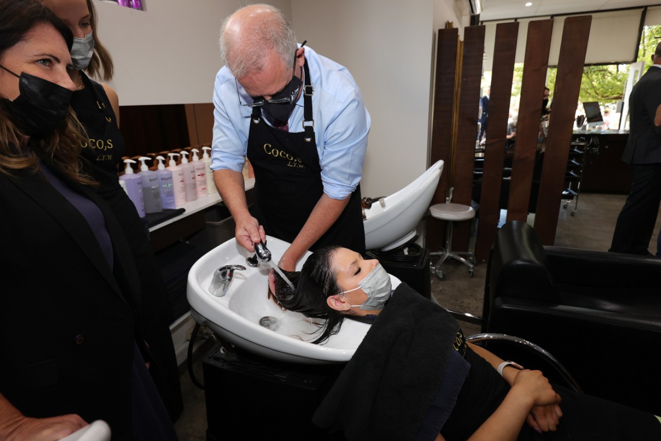Scott Morrison gets busy with a hose and some shampoo at Cocos Salon on Friday.