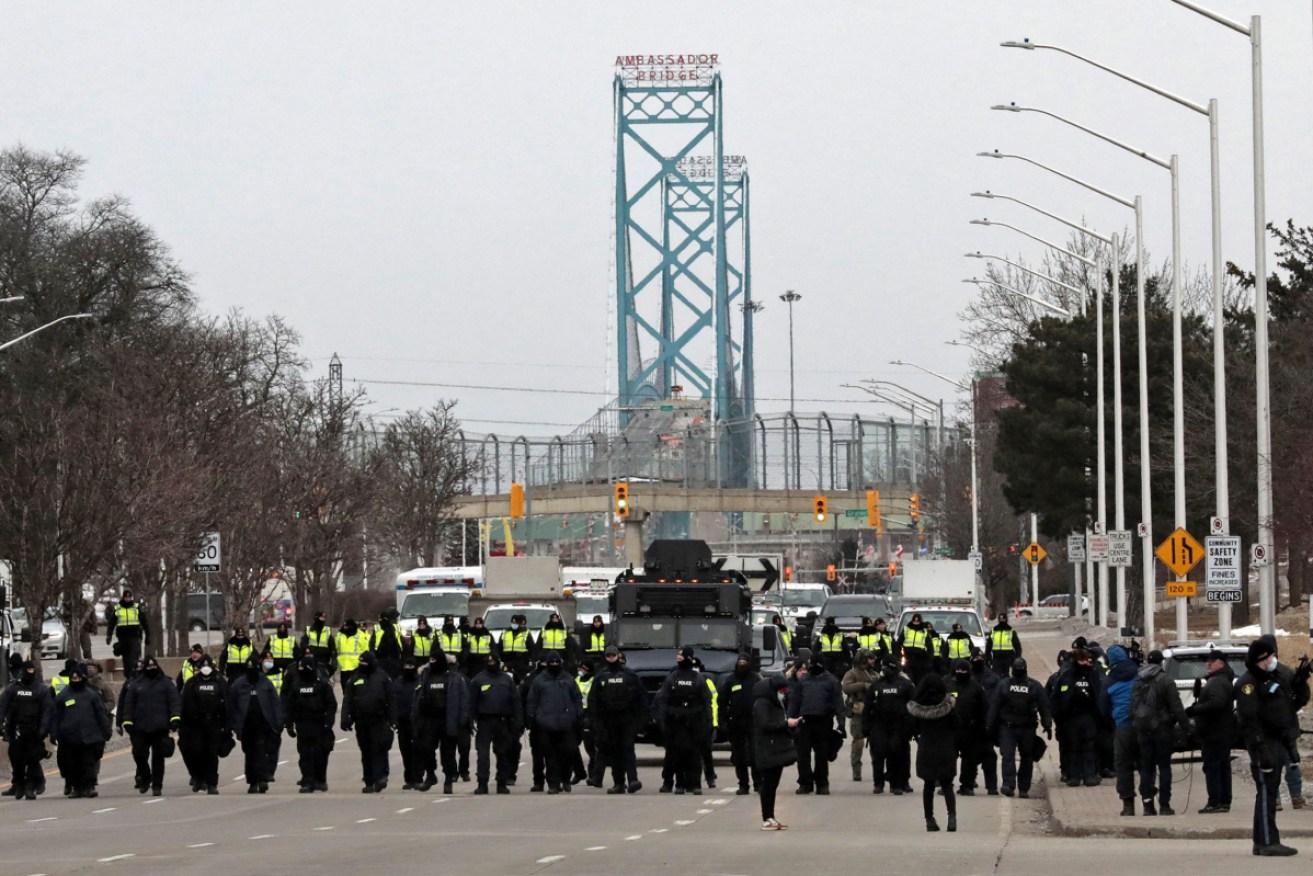 Police moved on protesters who have blocked the Ambassador Bridge between Canada and the US.