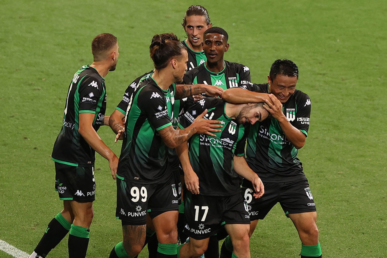 Western United teammates mob Ben Garuccio after his goal on Sunday. 