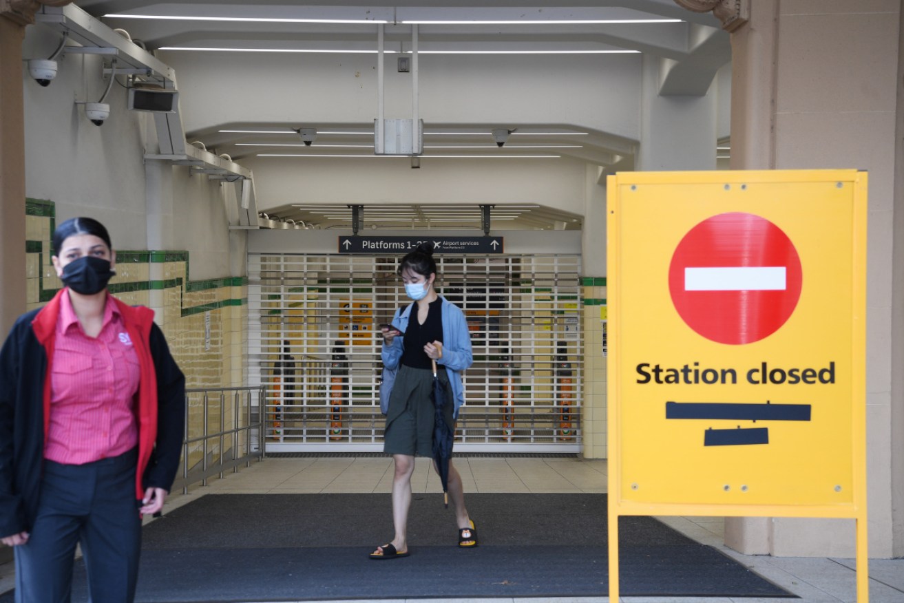 Commuters arrive at Sydney's shuttered Central Station on Monday morning.